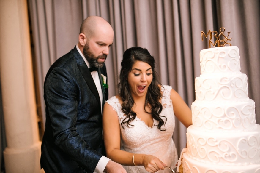 Bride and groom cut the cake from Isgro Bakery at Moulin by Brulee Catering wedding reception.