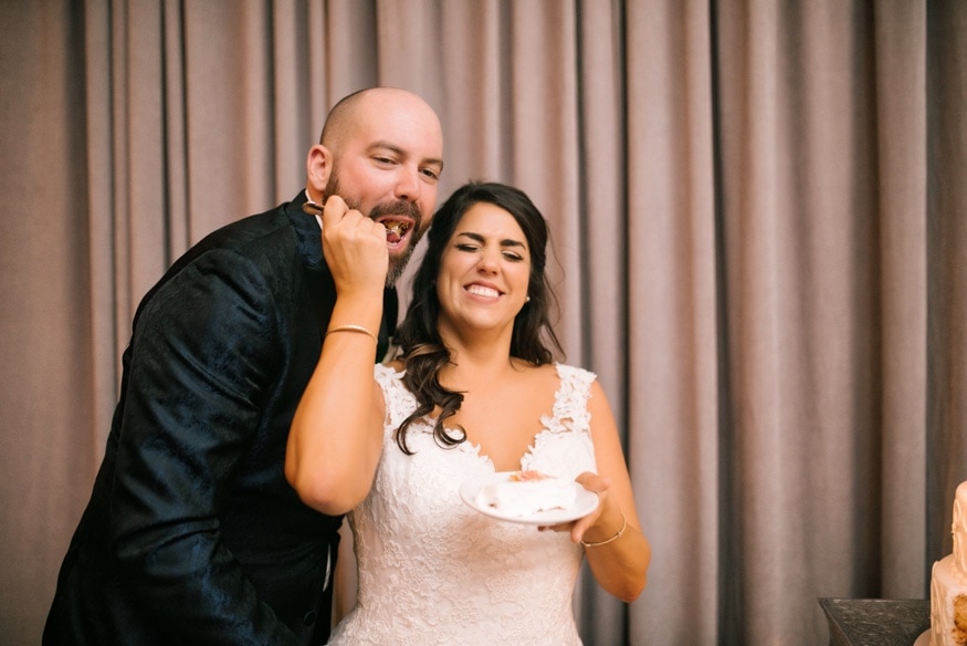 Bride and groom cut the cake from Isgro Bakery at Moulin at Sherman Mills wedding reception.