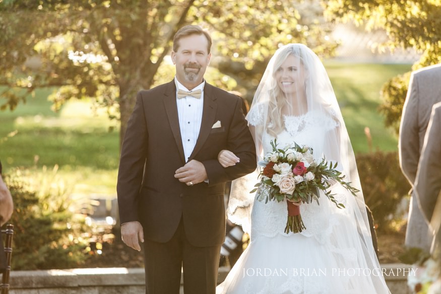 Father walking bride down aisle at Windows on the Water Frogbridge wedding ceremony.