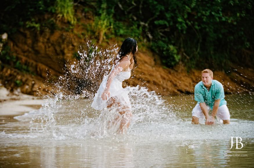 Laurie and Jason laughing together during Jamaica engagement session