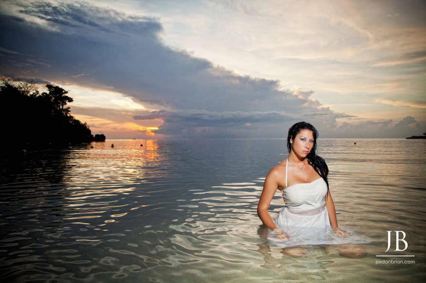 Laurie and Jason walking on beach during Jamaica destination engagement session