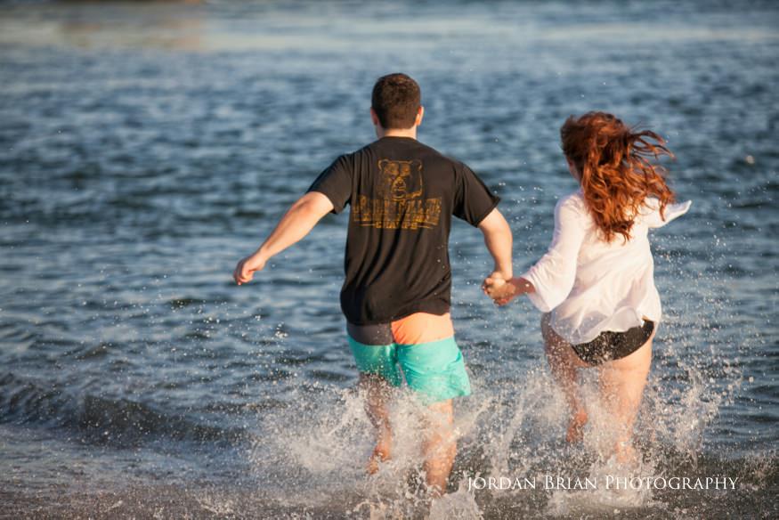 Couple running into water sea isle city photo