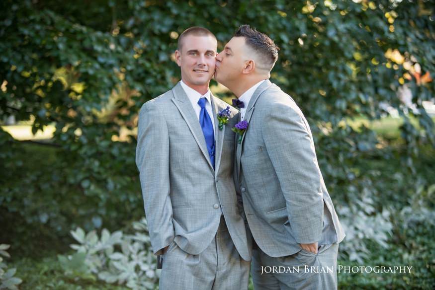groom kissing best man at knowlton mansion wedding