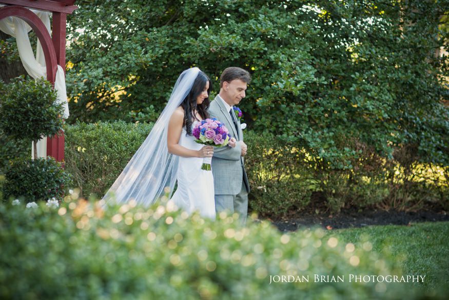 bride walking down aisle with father at wedding ceremony at knowlton mansion