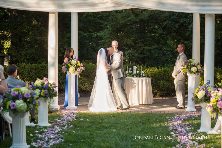 bride and groom kiss at knowlton mansion wedding ceremony