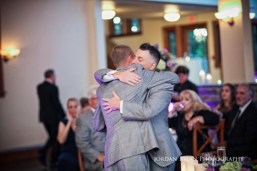 groom hugging best man after toast
