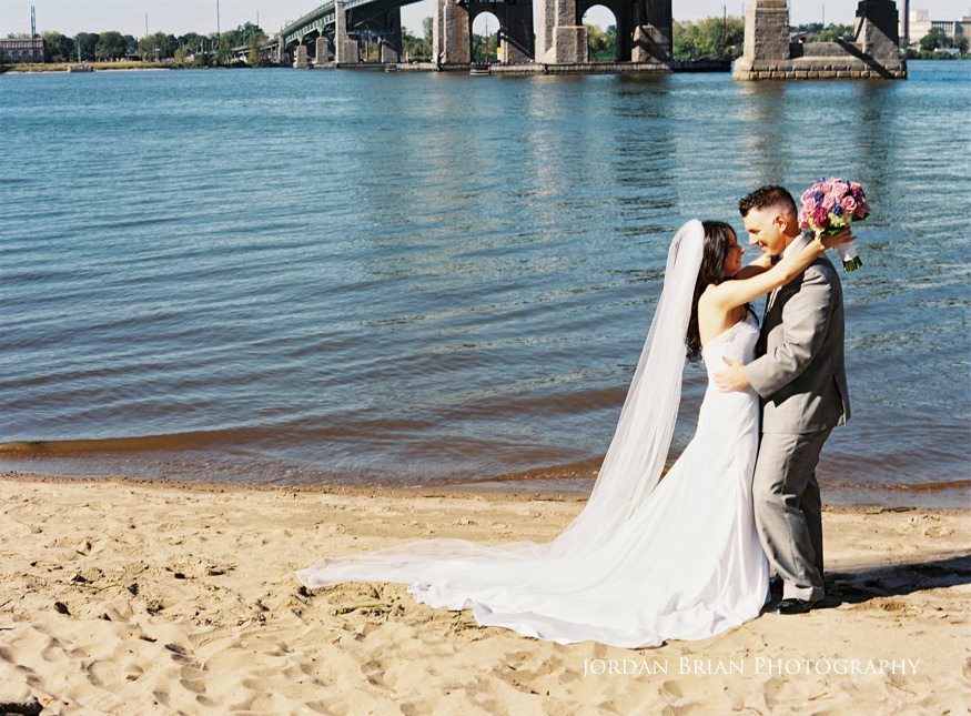 bride and groom portrait infront of tacony palmyra bridge
