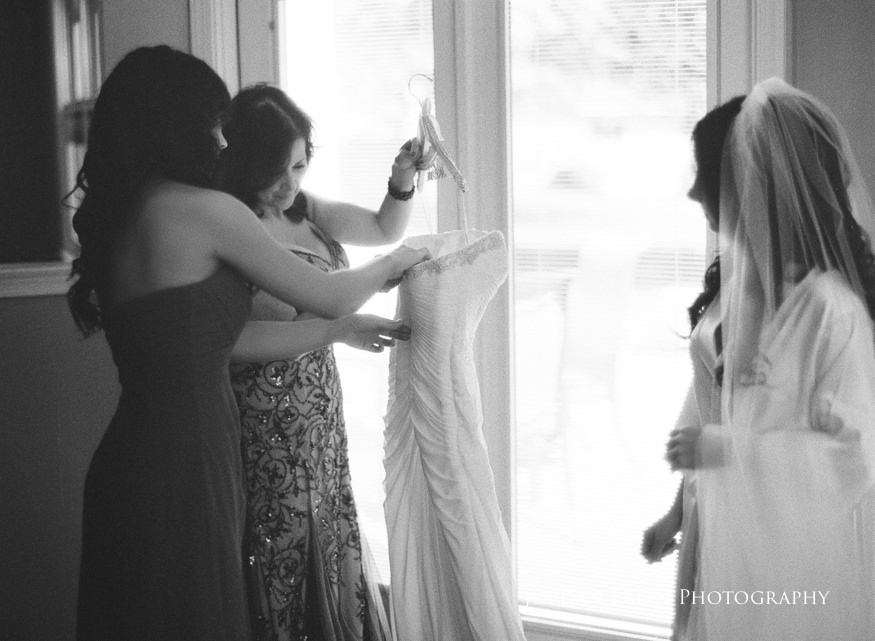 bride putting wedding dress on
