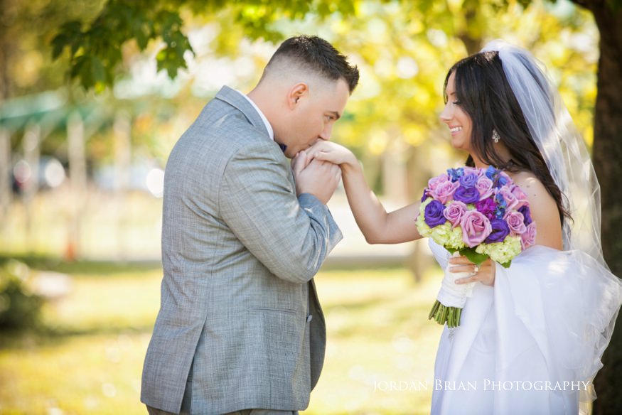 groom kissing bride at first look