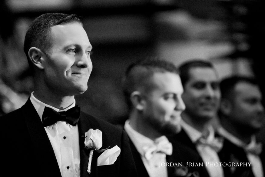 Groom looking at bride during ceremony at Fairmount Park Horticulture Center wedding.