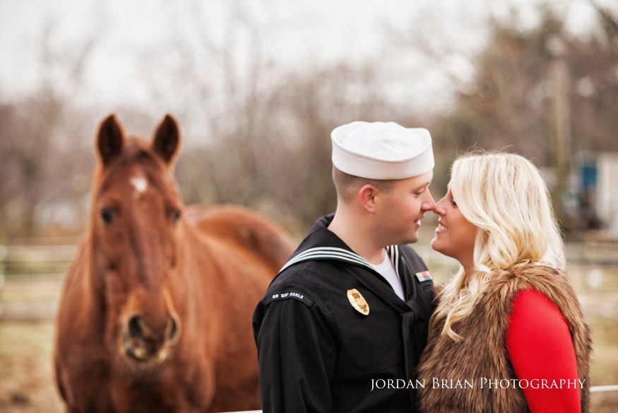 A horse photobombs Megan and Kevin during their South Jersey engagement session at the farm