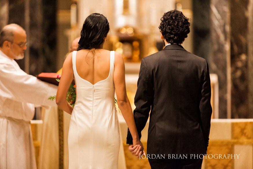 cathedral basilica wedding holding hands