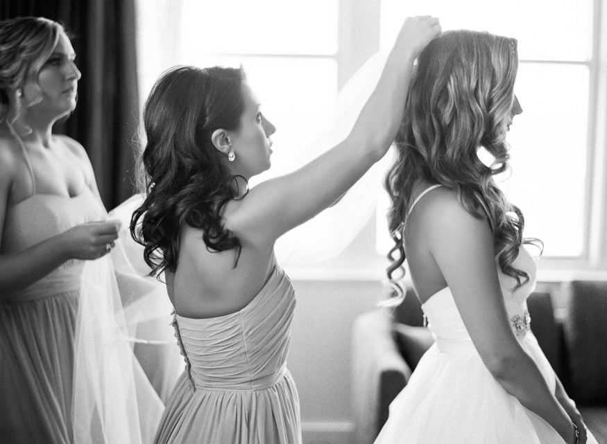 Bride getting into her dress at the Loews Hotel before a Crystal Tea Room wedding