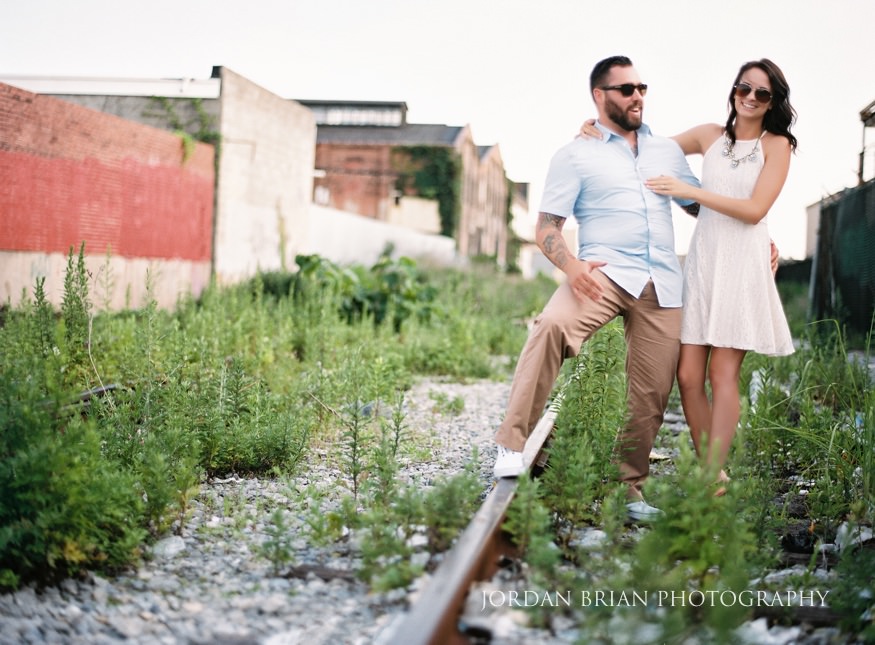 portrait of couple on traintracks at philadelphia engagement session