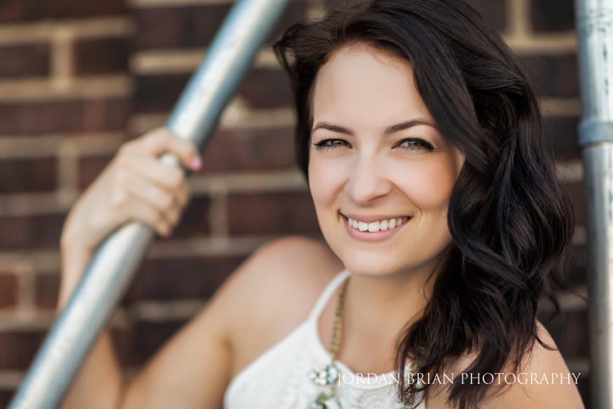 bride infront of brick wall at philadelphia engagment