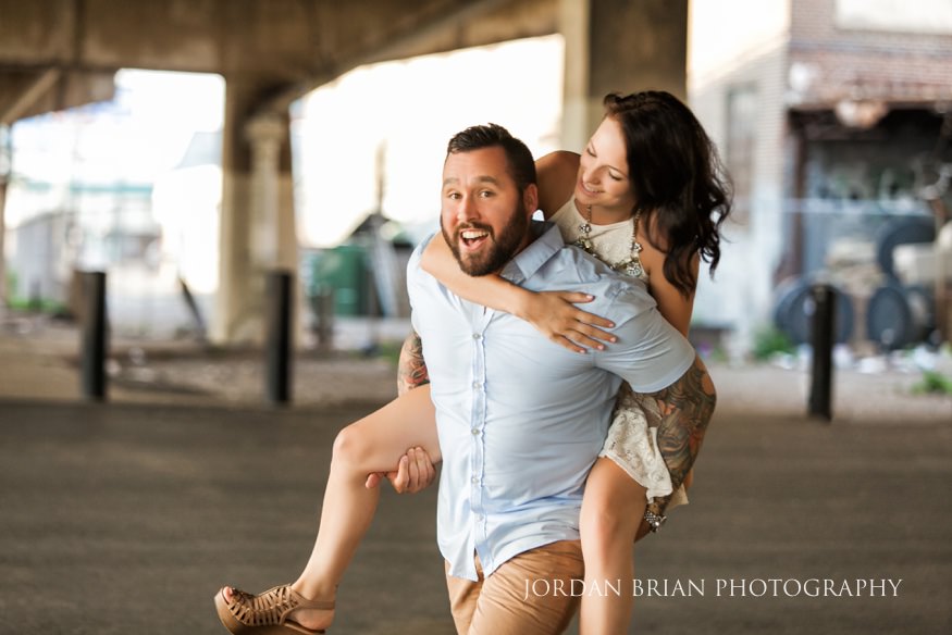 philadelphia engagement session groom giving bride piggyback ride