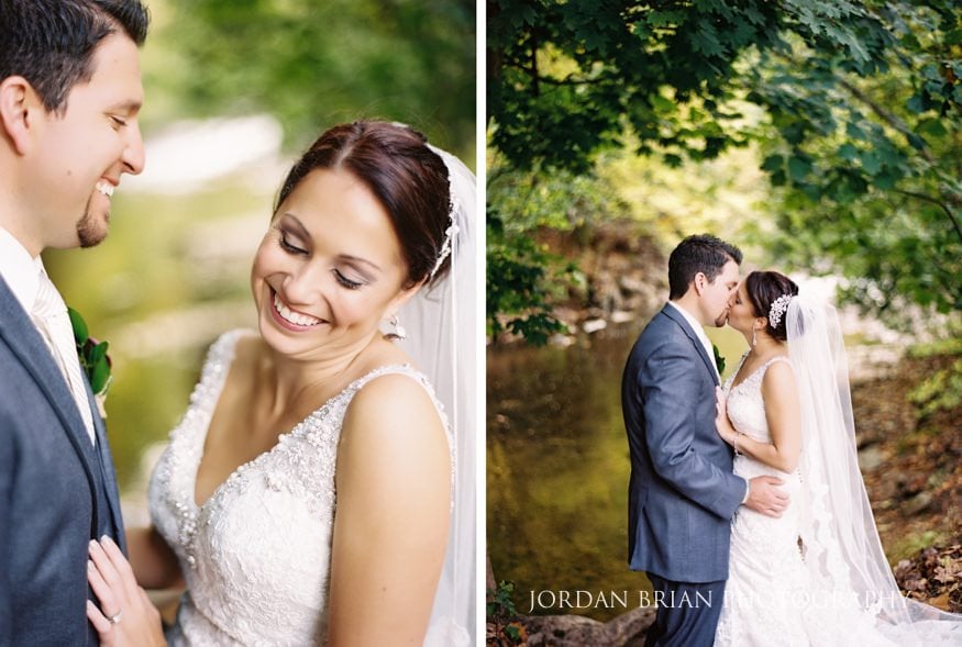 Bride and groom kiss Old Mill at Rose Valley grounds
