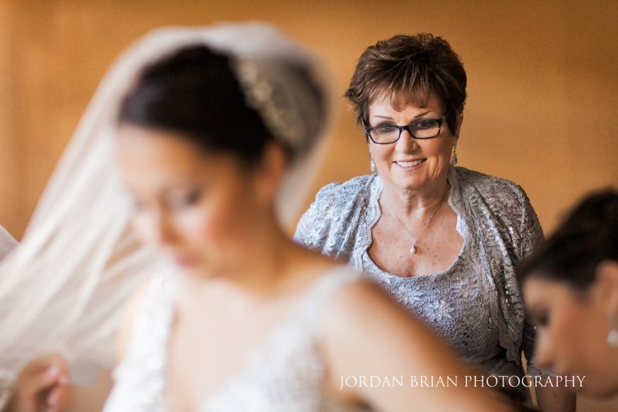 Bride finishing veil before Old Mill at Rose Valley wedding