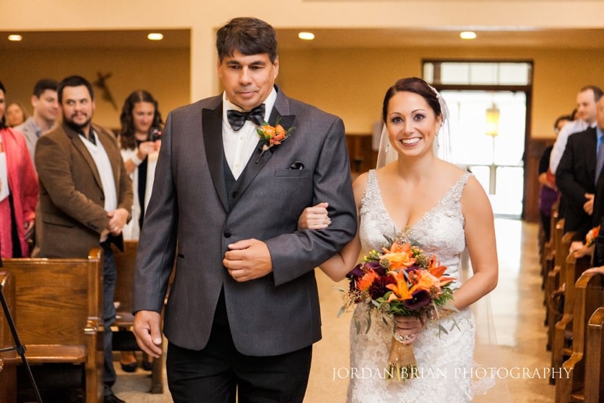 Father walking bride down aisle St Raphael Catholic Church