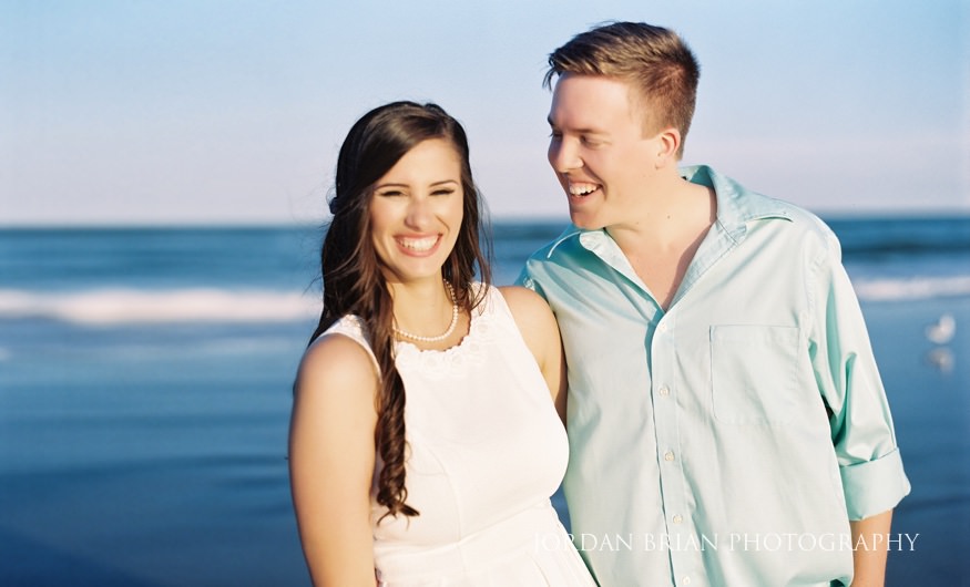 Rebecca and Mat walking the sand at their Wildwood beach engagement session