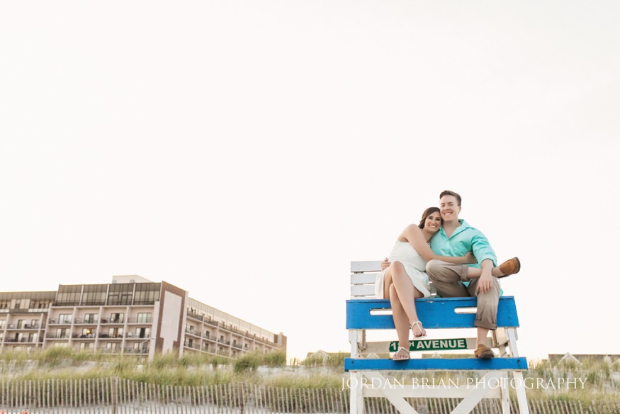 Rebecca and Mat climbing the Wildwood lifeguard tower during their engagement session