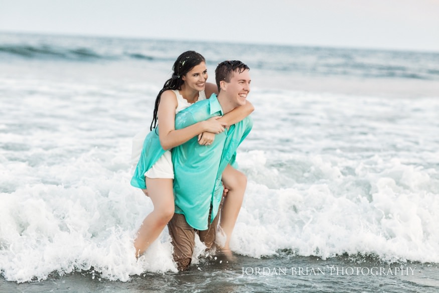 Rebecca and Mat splashing in the Atlantic Ocean at Wildwood beach engagement