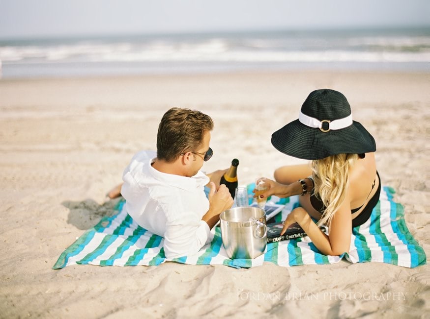 Ventnor beach Engagement photos on blanket with champagne