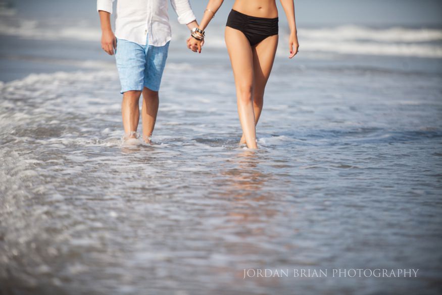 Simona and Brandon portrait under the Ventnor pier with dramatic light and shadow