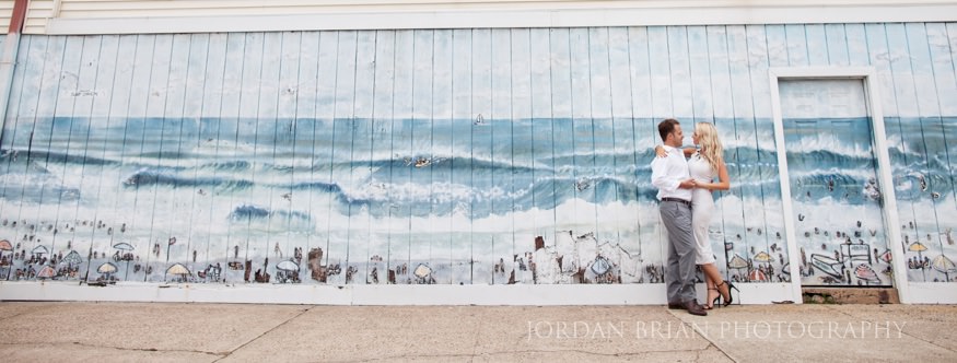 Wide shot of Simona and Brandon on the Ventnor bayside pier at dusk