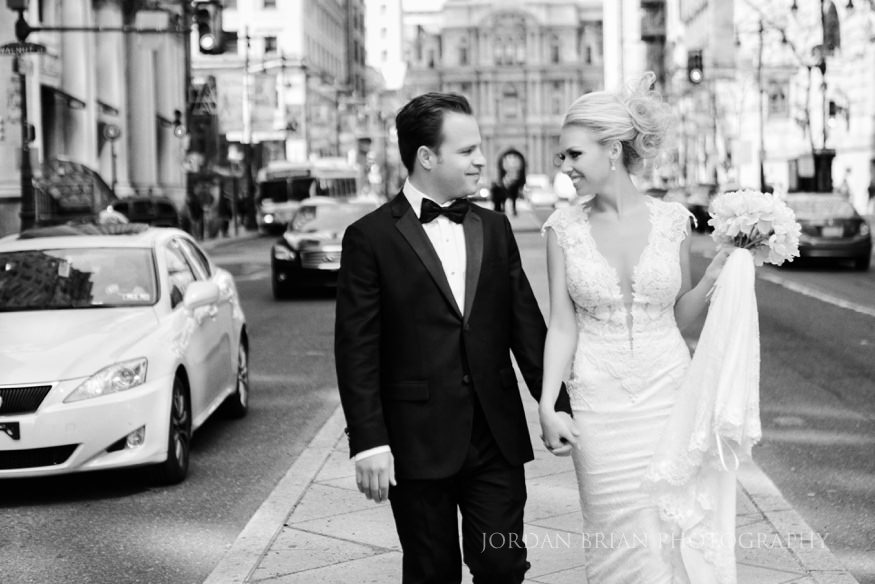 bride and groom portraits infront of city hall before curtis center wedding