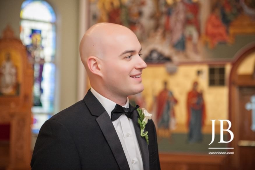 Stasia and Evan exchanging vows at St. Barbara's Greek Orthodox Church ceremony