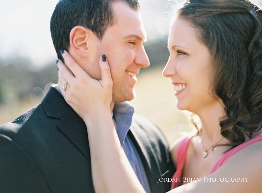 Vintage style engagement portrait of Tara and Paul by the barn doors