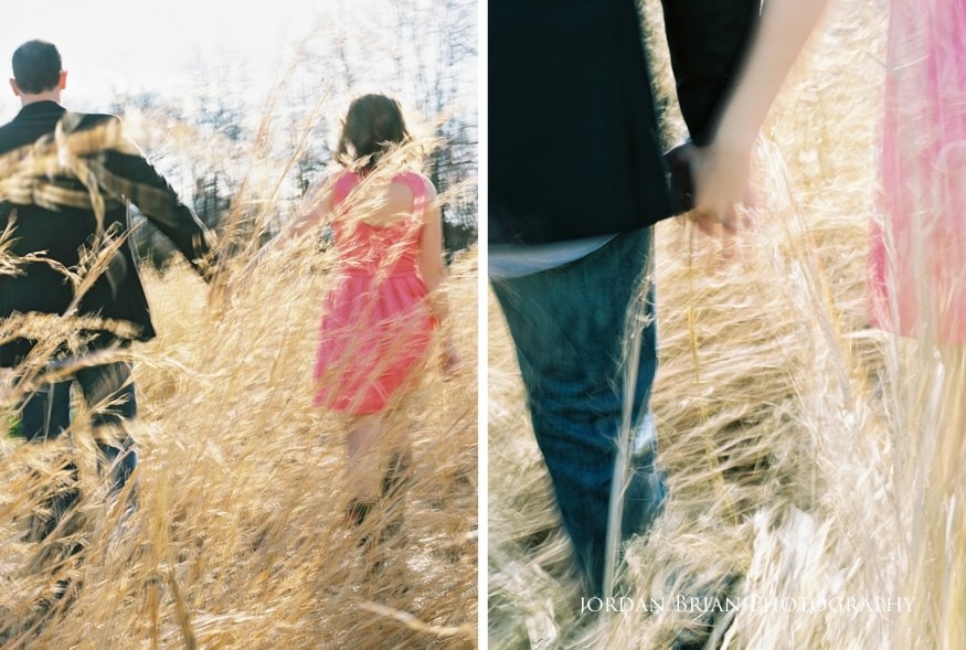 Engagement photograph of Tara and Paul against old barn wood