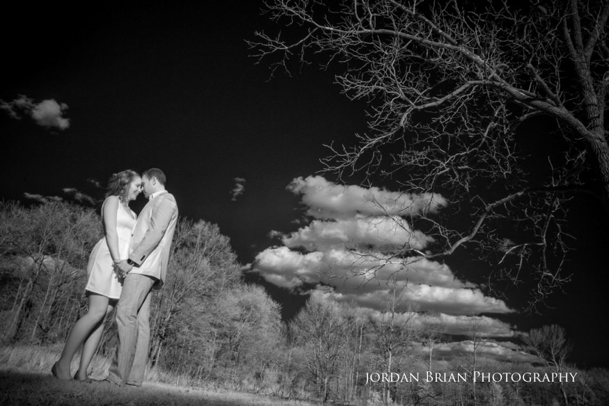 Tara and Paul holding hands beside the vintage barn