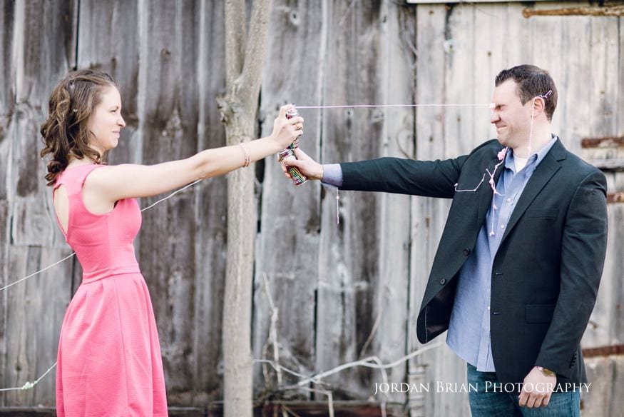 Tara and Paul spraying silly string to end their engagement session
