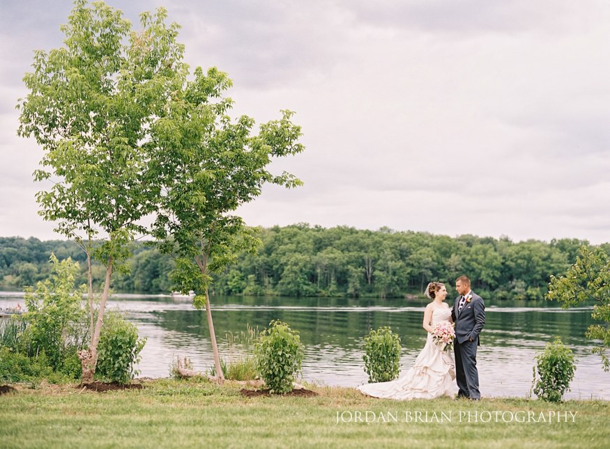 bride and groom portraits at lake house in wedding 