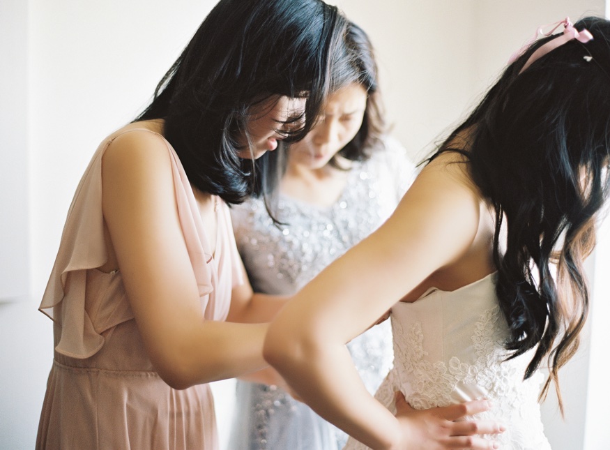 Bride getting ready before Brookyln Botanic Garden wedding. Wedding dress by Liancarlo from Kleinfeld Bridal.