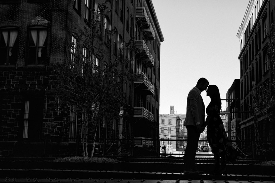 The Rail Park Philadelphia engagement session on metal structure between buildings