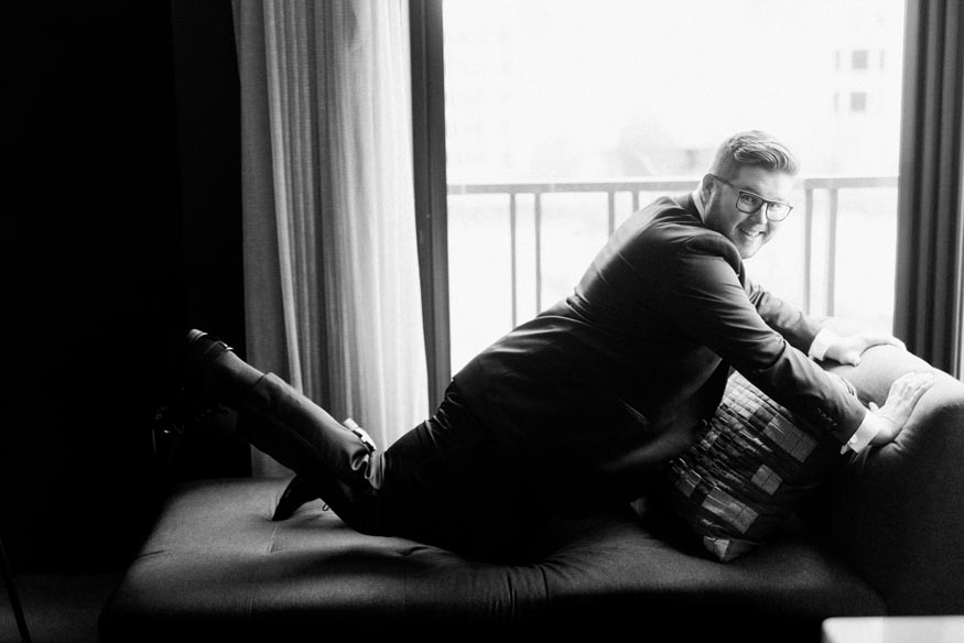 Philadelphia wedding groom posing on chair