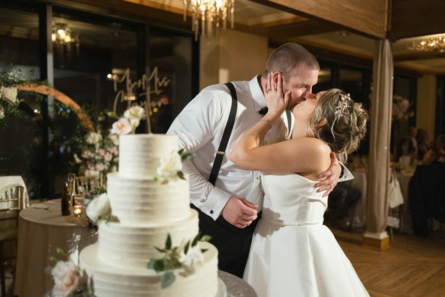 Couple kiss after cake cutting Lambertville Inn wedding