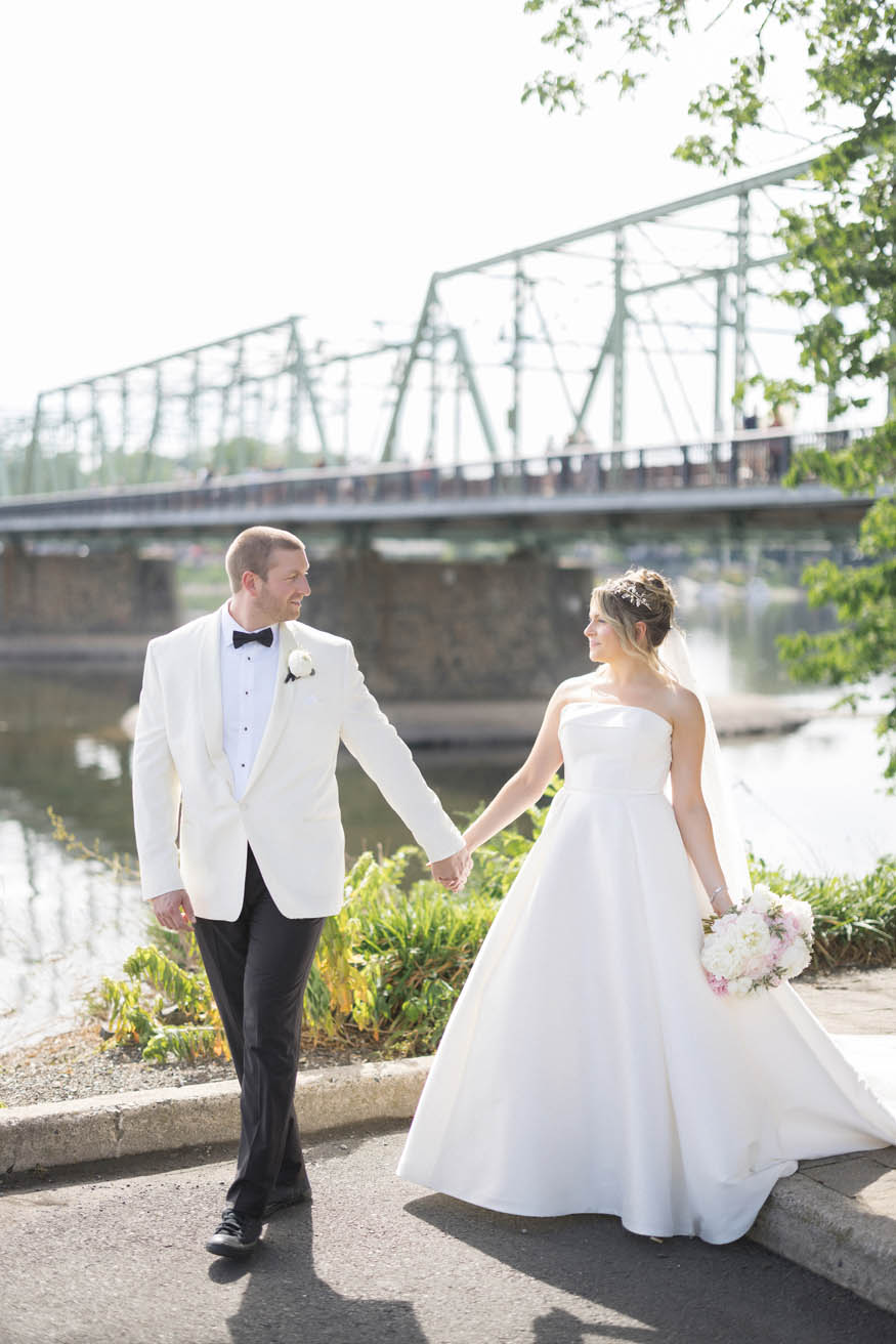 Couple walking together Lambertville bridge portrait