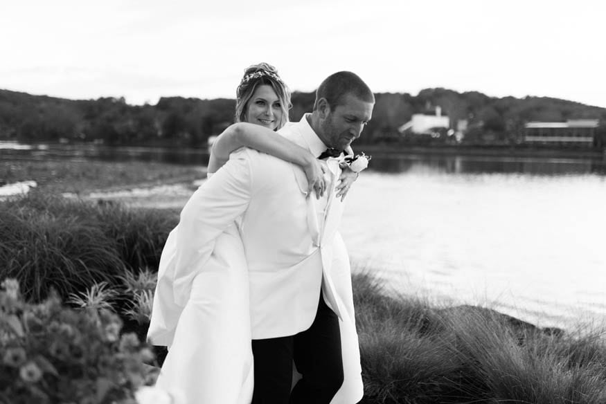 Bride on groom back sunset portrait Lambertville Inn