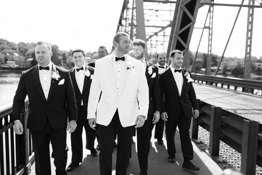 Bridesman walking on bridge Lambertville NJ wedding