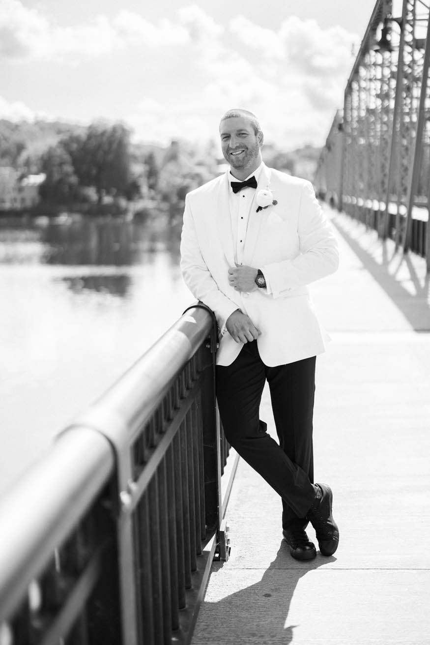 Groom leaning portrait Lambertville bridge NJ