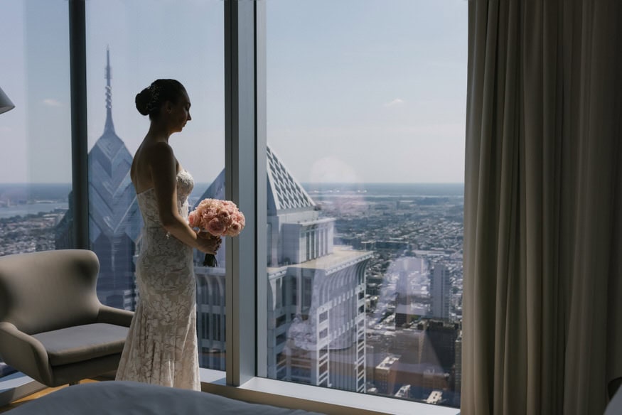 Sara looking out over Philadelphia skyline from Four Seasons suite