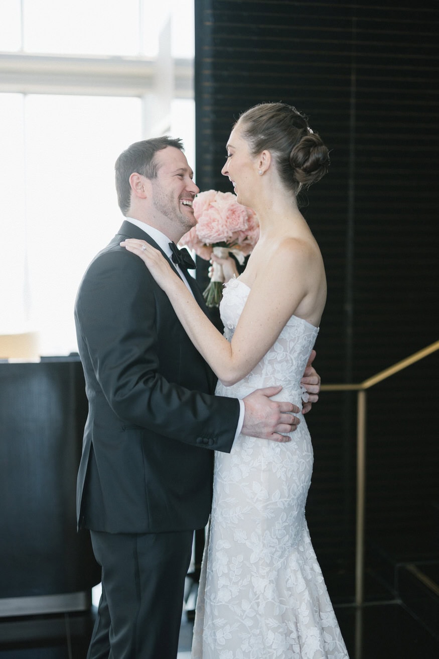 Bride and groom first look embrace at Four Seasons Sky Lounge Philadelphia