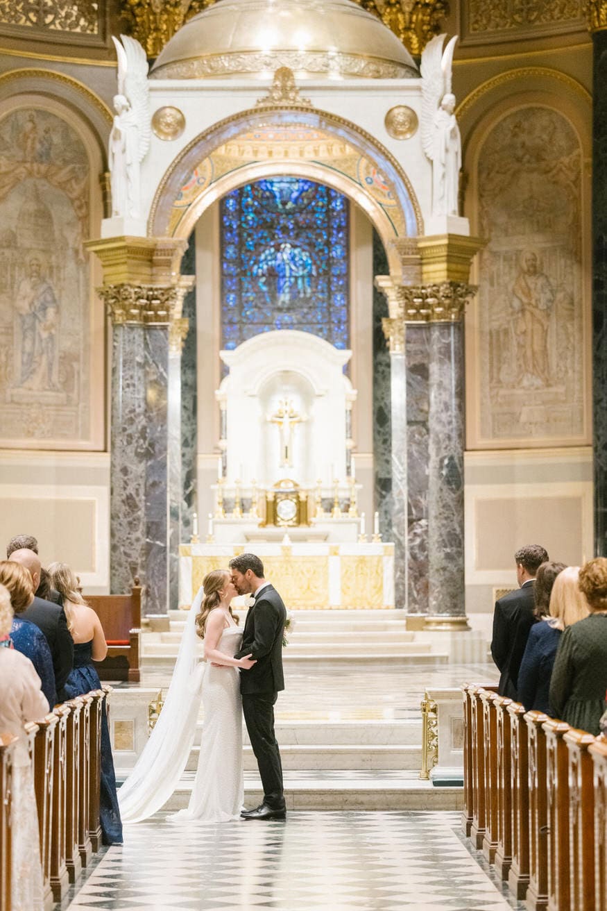 First kiss at Cathedral Basilica of Saints Peter and Paul wedding