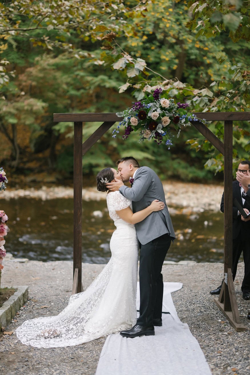 First kiss at Valley Green Inn riverside ceremony