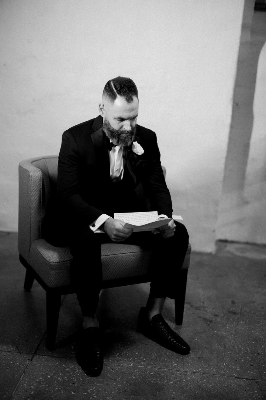 Groom reading heartfelt letter Curtis Arboretum wedding day