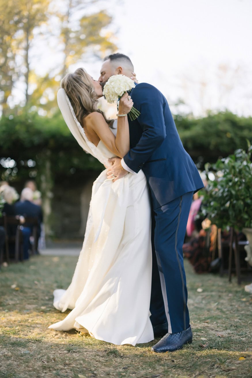 Bride and groom kiss after ceremony Curtis Arboretum